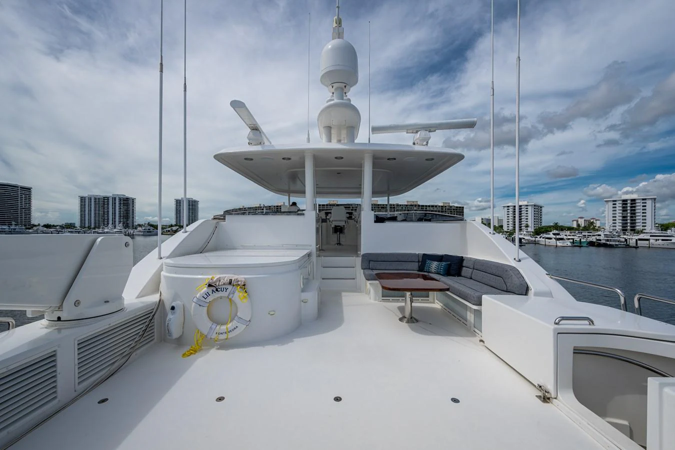 The flybridge offers a spacious and inviting area for relaxation and entertainment with a stunning view of the marina. aboard LILA CUY Yacht for Sale