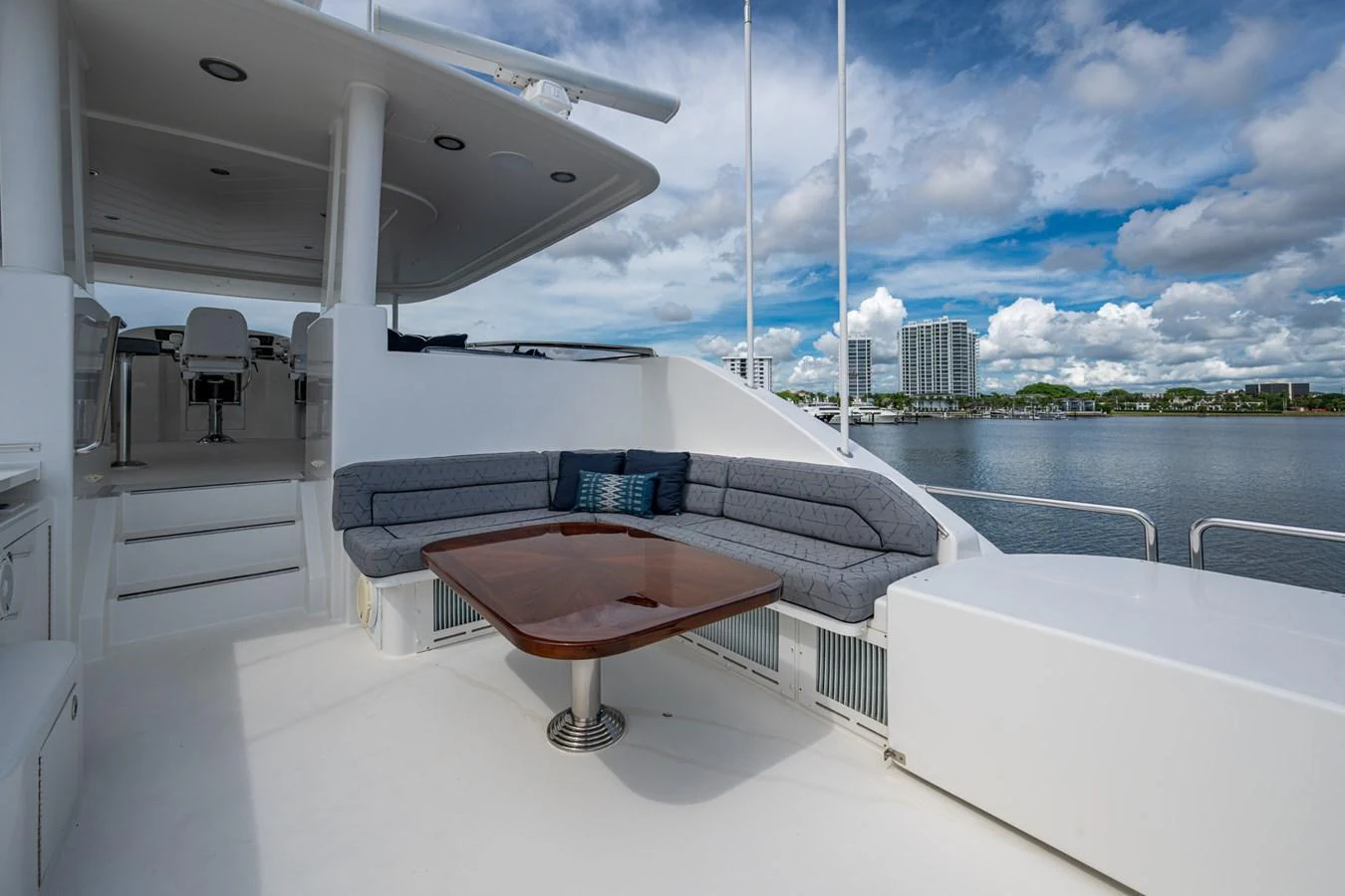 The yacht's aft deck features a comfortable seating area with a wooden table, perfect for enjoying the scenic views. aboard LILA CUY Yacht for Sale
