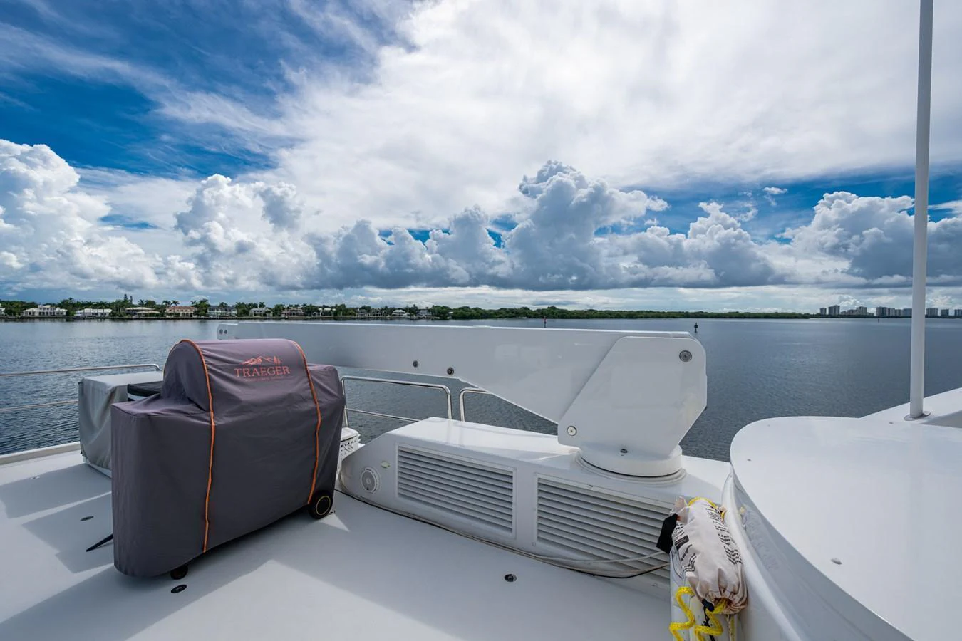 The flybridge offers a serene view of the water under a partly cloudy sky. aboard LILA CUY Yacht for Sale