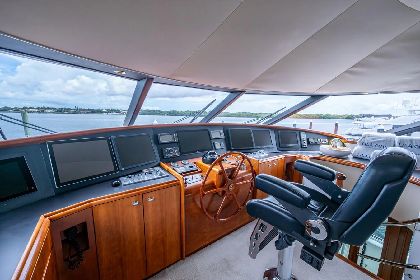 The helm station features state-of-the-art navigation equipment and a comfortable captain's chair with panoramic views. aboard LILA CUY Yacht for Sale