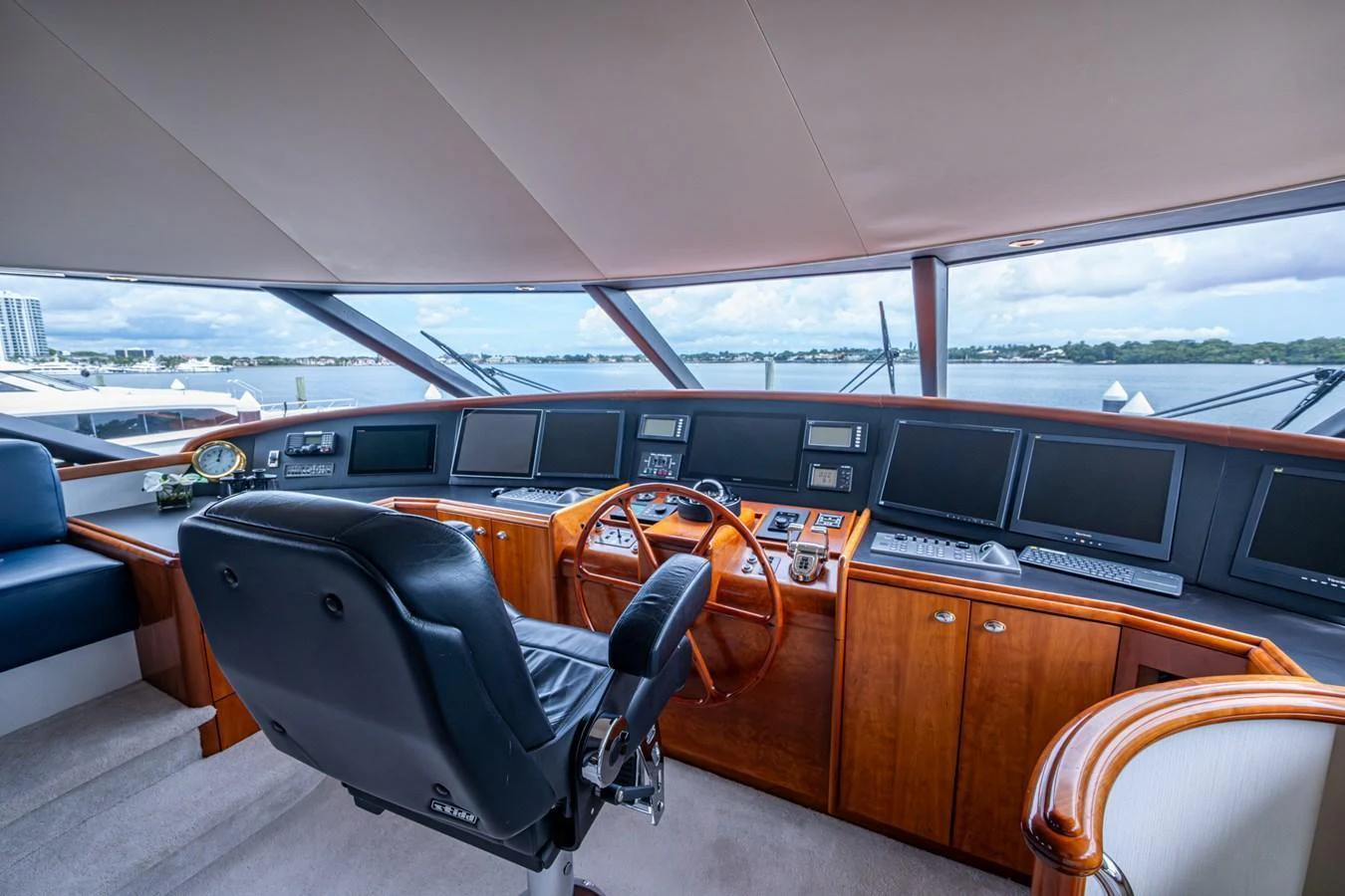 The helm station features a sophisticated array of navigation equipment and a comfortable captain's chair. aboard LILA CUY Yacht for Sale