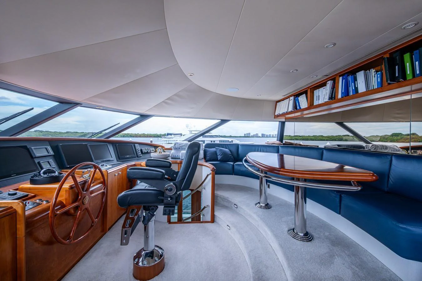 The helm area features a sophisticated control station with plush seating and panoramic views. aboard LILA CUY Yacht for Sale