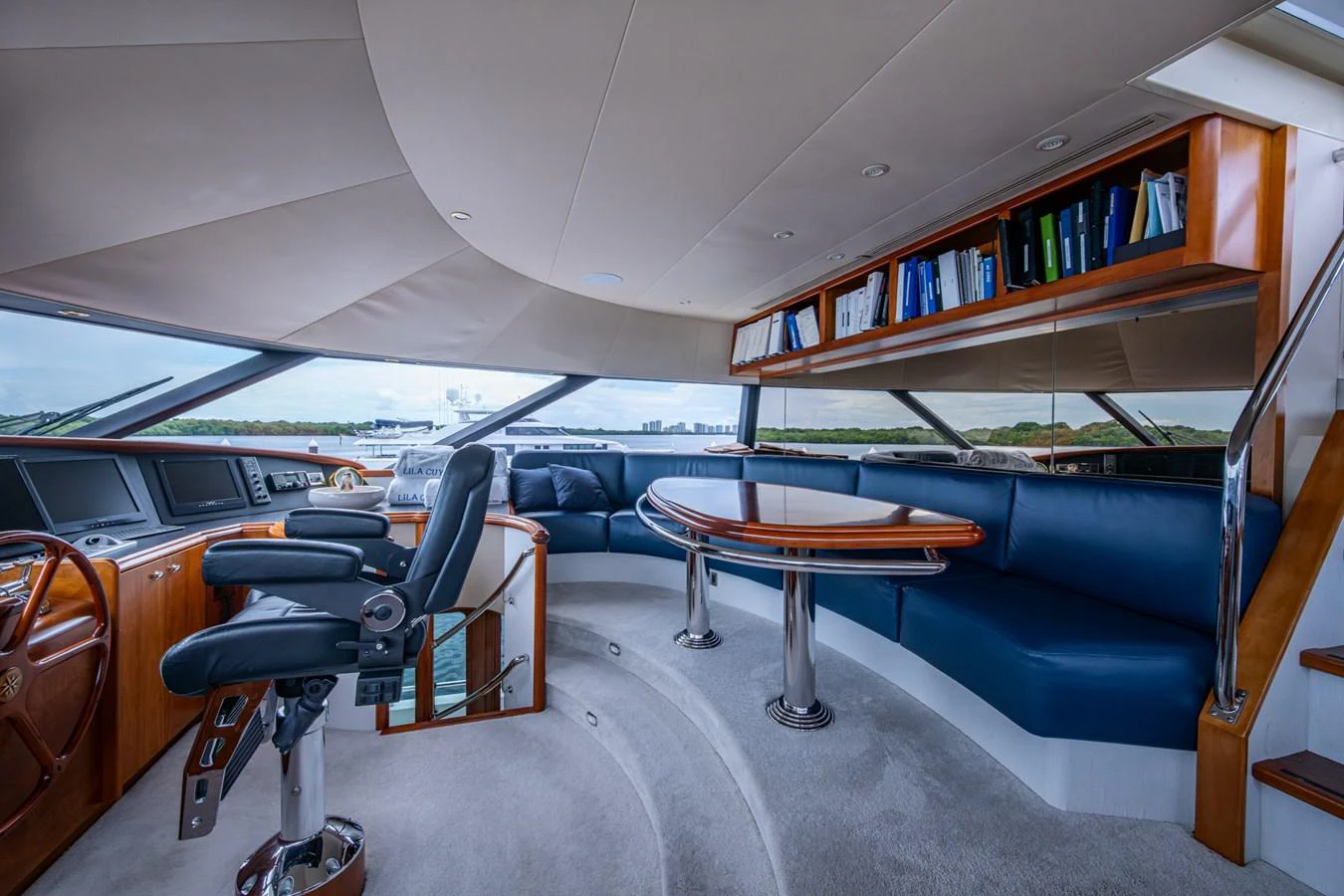 The helm area features a luxurious seating arrangement with panoramic views and a sophisticated control station. aboard LILA CUY Yacht for Sale