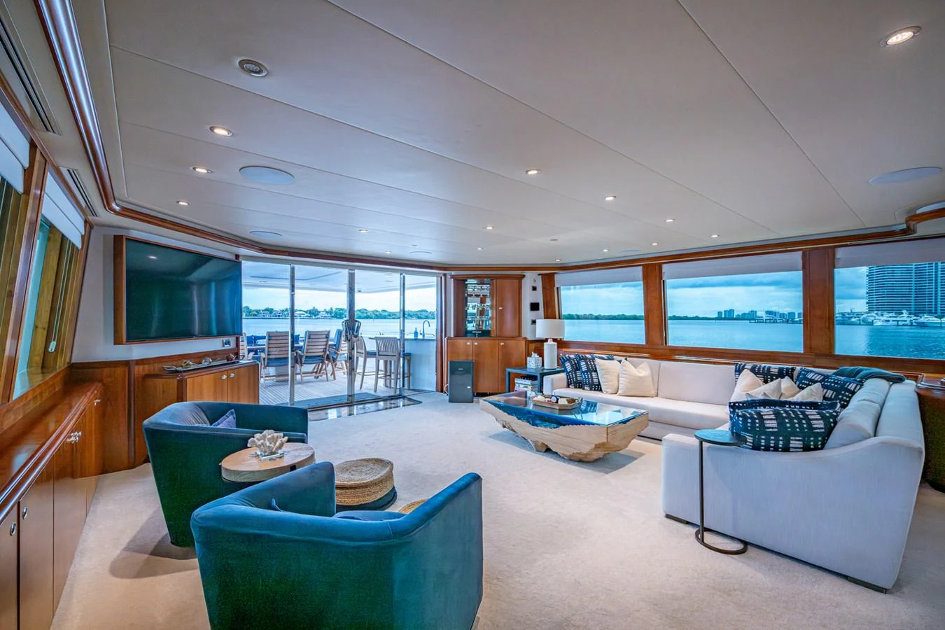 The spacious salon features luxurious seating with panoramic views through large windows. aboard LILA CUY Yacht for Sale