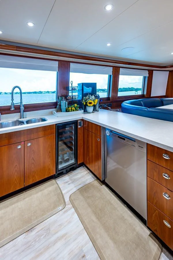 The galley features modern appliances and a stunning view through large windows. aboard LILA CUY Yacht for Sale