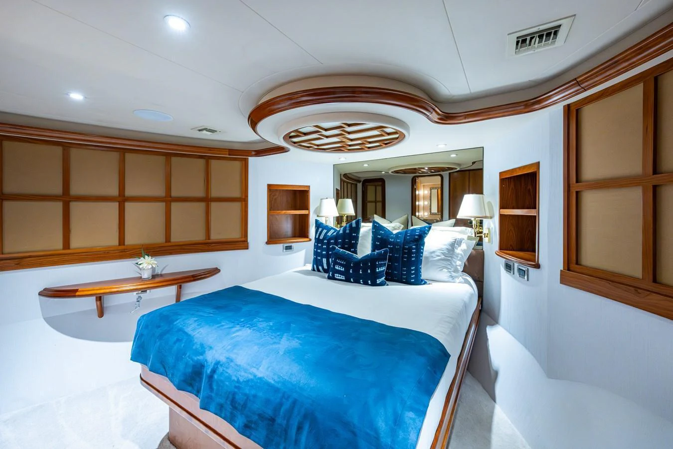 A luxurious stateroom featuring a comfortable bed with elegant decor and ample lighting. aboard LILA CUY Yacht for Sale