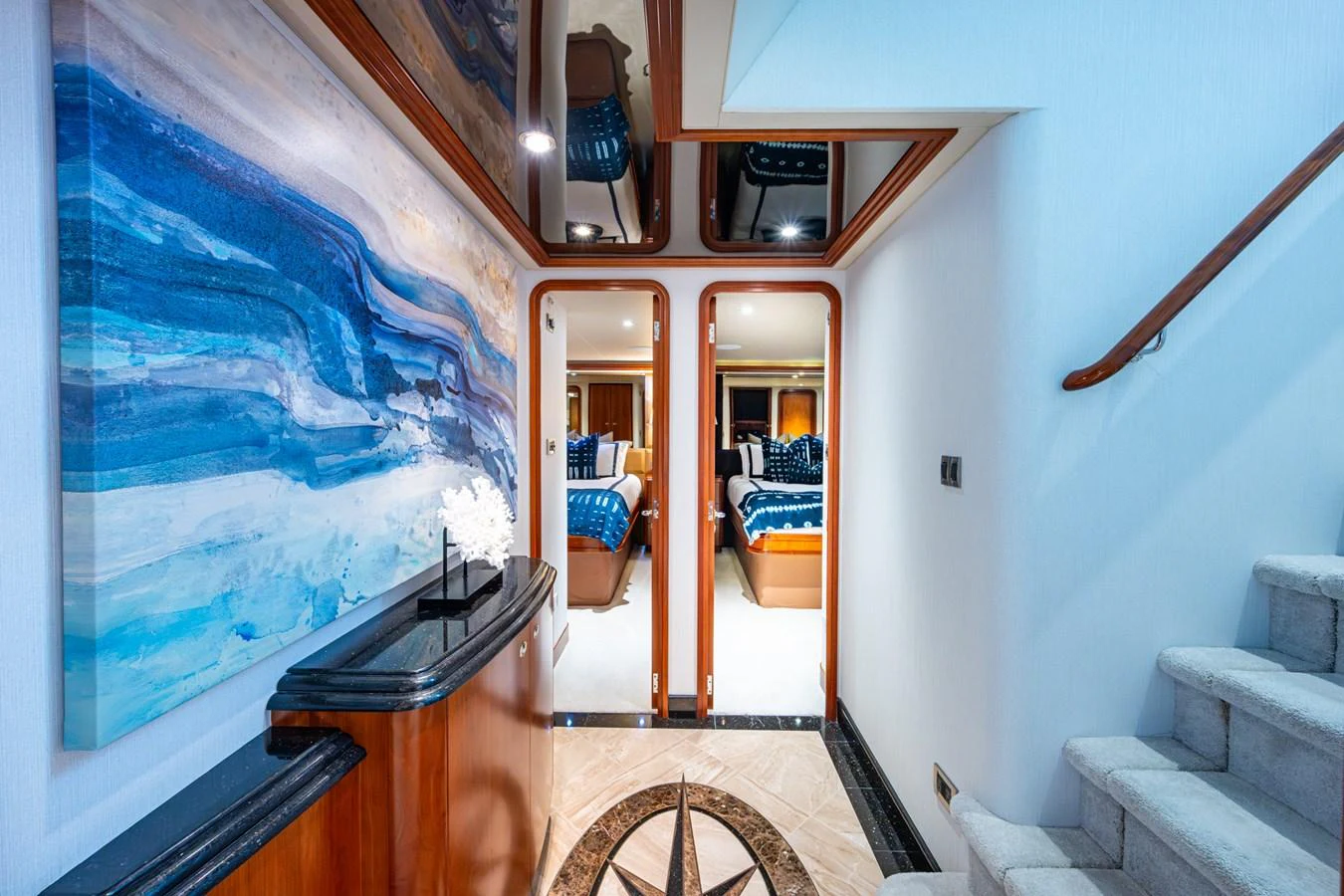 A luxurious hallway with elegant decor and access to staterooms. aboard LILA CUY Yacht for Sale