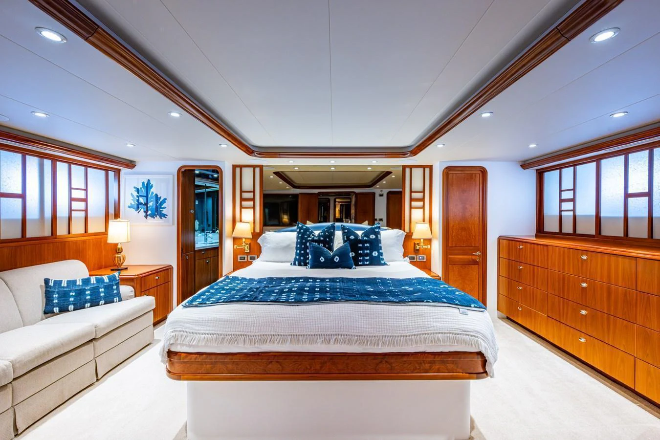 The master stateroom features a spacious bed with elegant wooden accents and luxurious decor. aboard LILA CUY Yacht for Sale