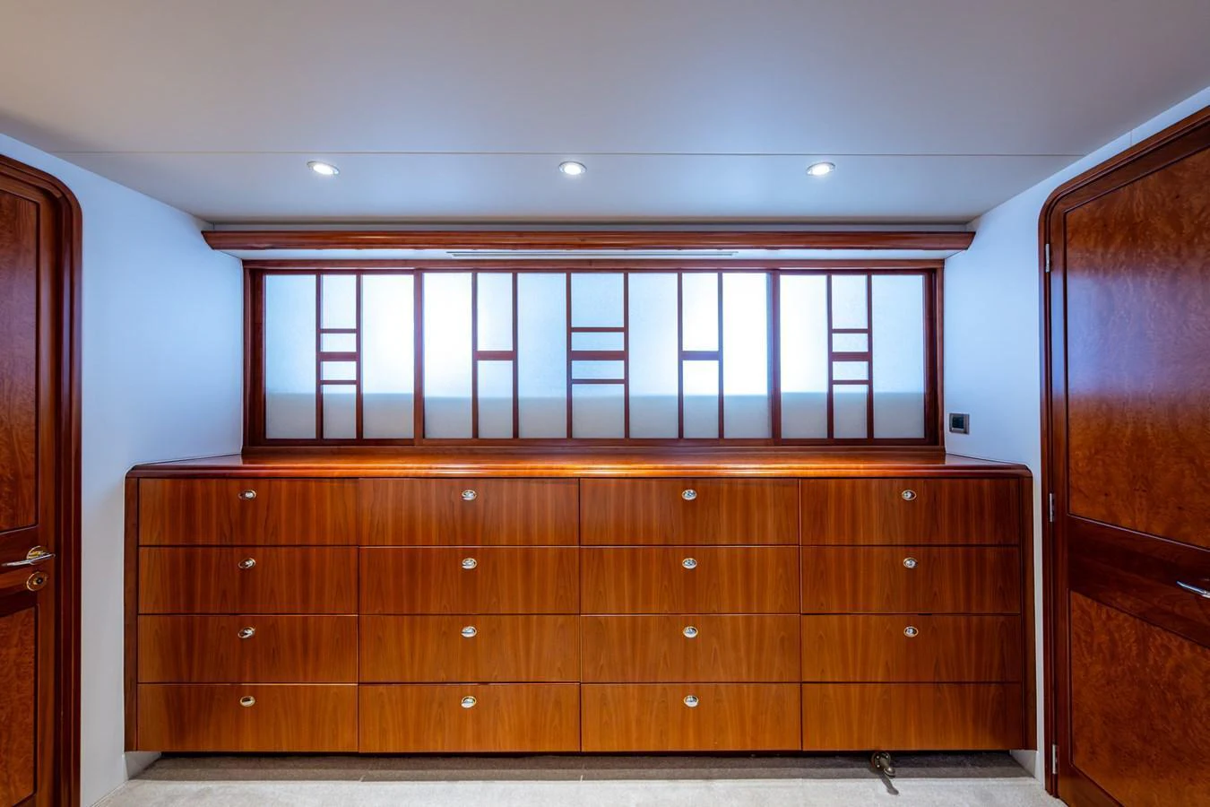 The yacht's interior features elegant wooden cabinetry with a modern design. aboard LILA CUY Yacht for Sale