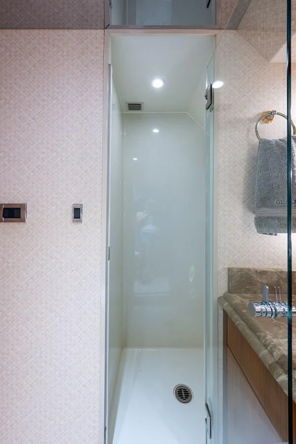 A compact and modern yacht bathroom with a sleek shower area and elegant fixtures. aboard LILA CUY Yacht for Sale