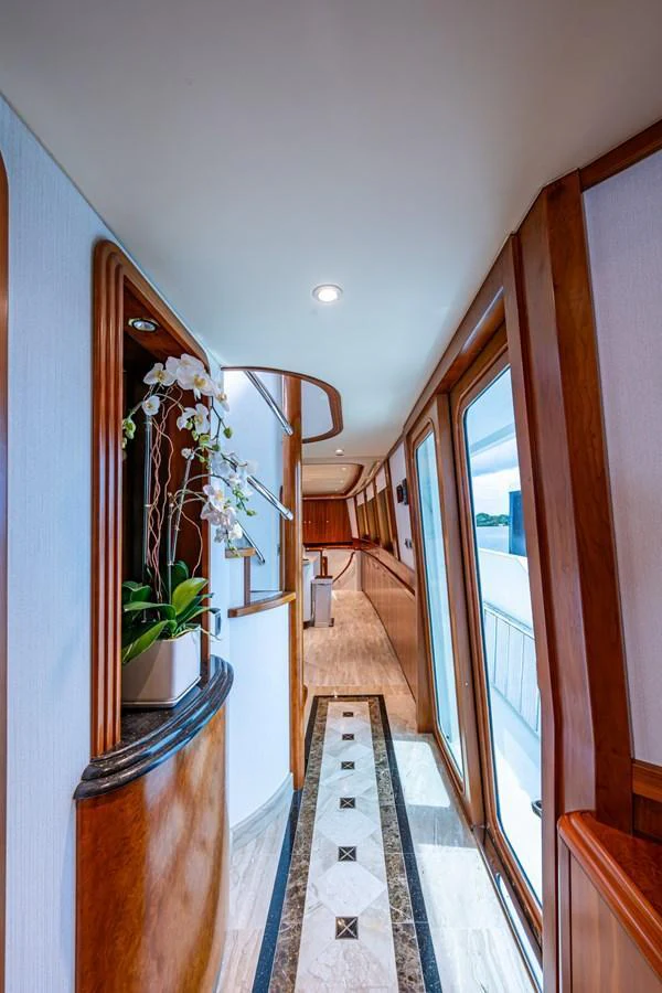 A beautifully designed hallway with large windows and elegant decor. aboard LILA CUY Yacht for Sale