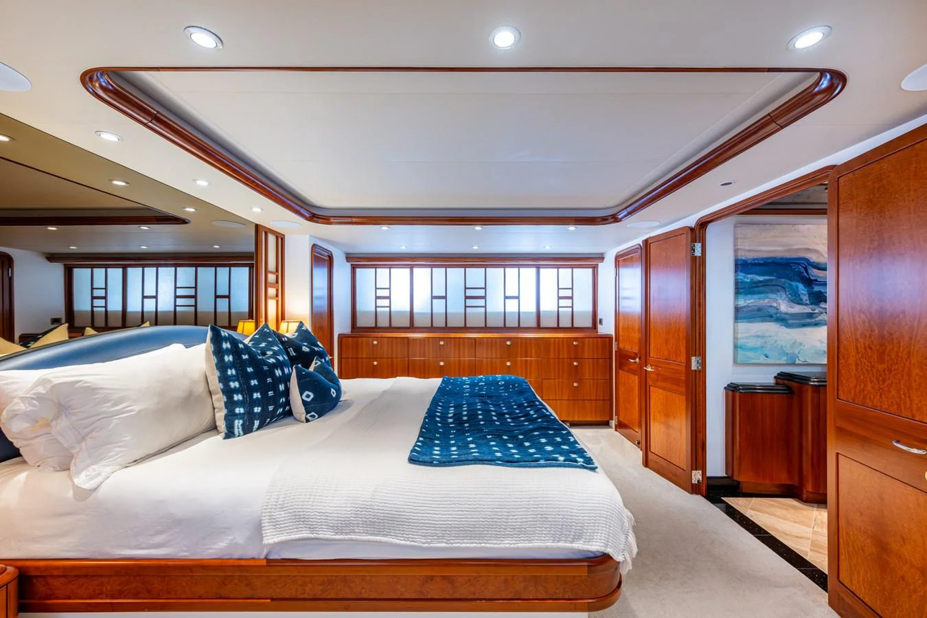 The master stateroom features elegant wood finishes and luxurious bedding for ultimate comfort. aboard LILA CUY Yacht for Sale