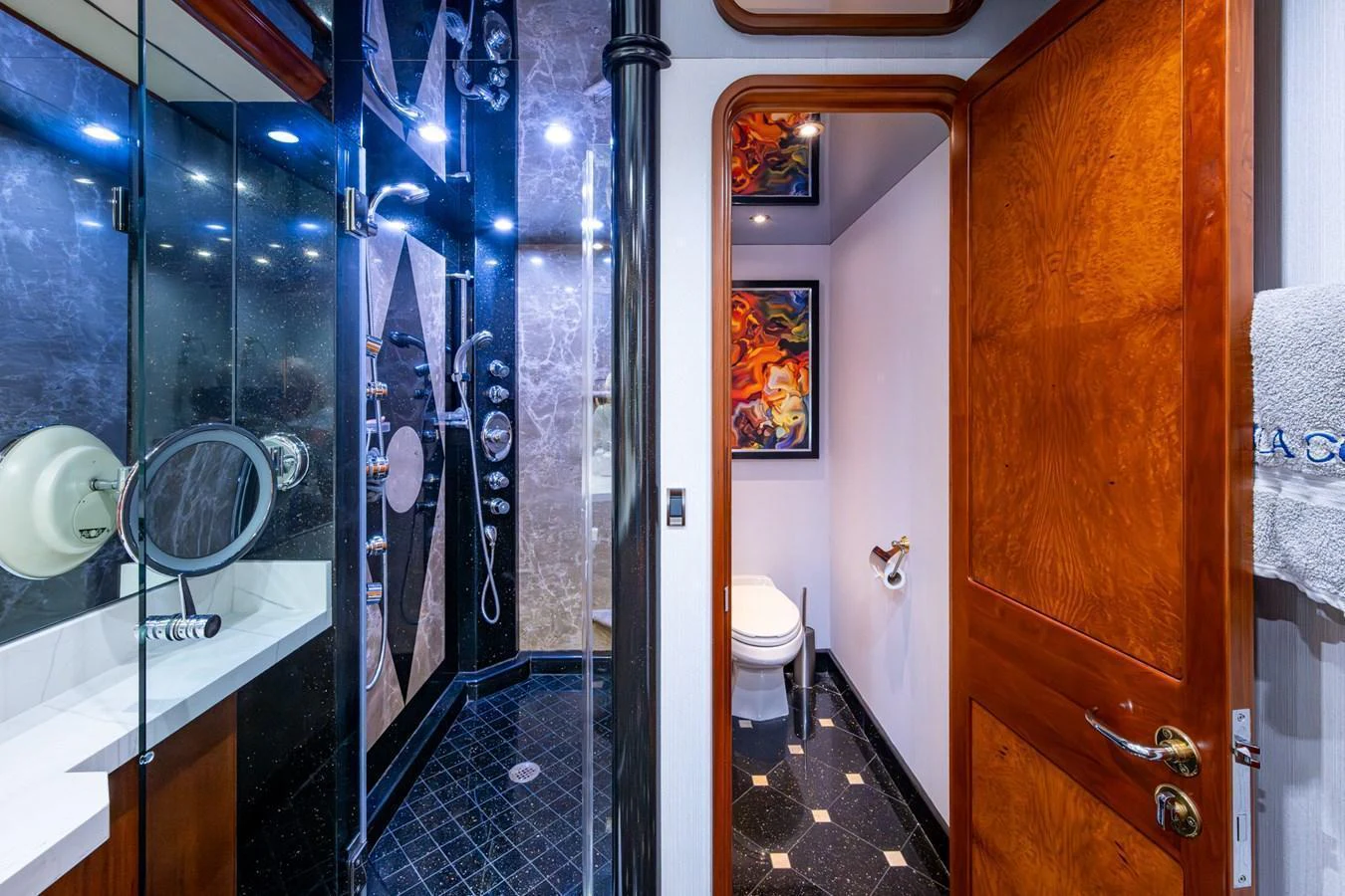 The yacht's bathroom features a modern shower and elegant wood finishes. aboard LILA CUY Yacht for Sale