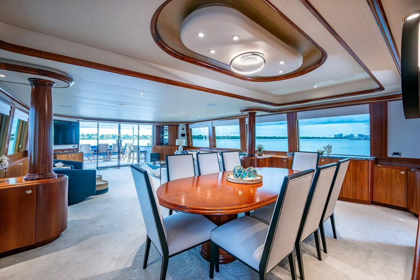 The yacht's dining area features elegant seating and panoramic views through large windows. aboard LILA CUY Yacht for Sale