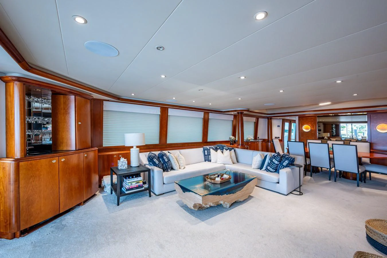 The yacht's salon features elegant wood paneling, plush seating, and a sophisticated dining area. aboard LILA CUY Yacht for Sale