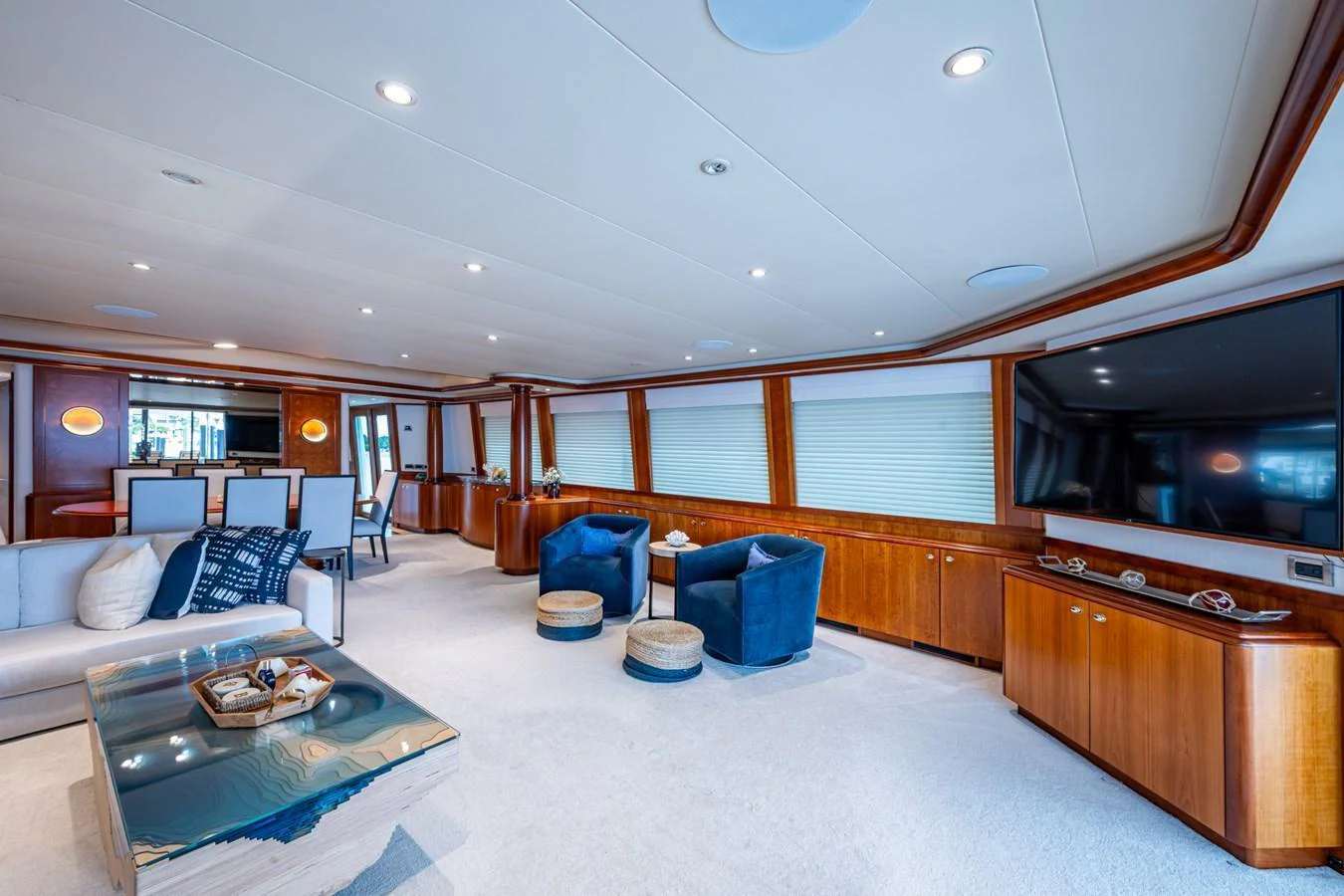 The yacht's salon features a spacious and elegant seating area with plush furnishings and a large TV. aboard LILA CUY Yacht for Sale