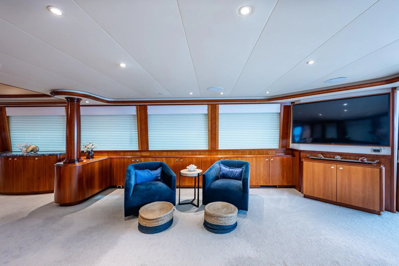 The salon features plush seating, a large TV, and elegant wood finishes, creating a cozy and luxurious atmosphere. aboard LILA CUY Yacht for Sale