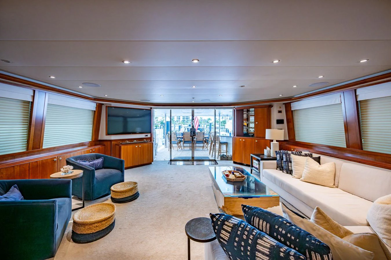 The spacious salon features elegant seating and a view towards the aft deck. aboard LILA CUY Yacht for Sale