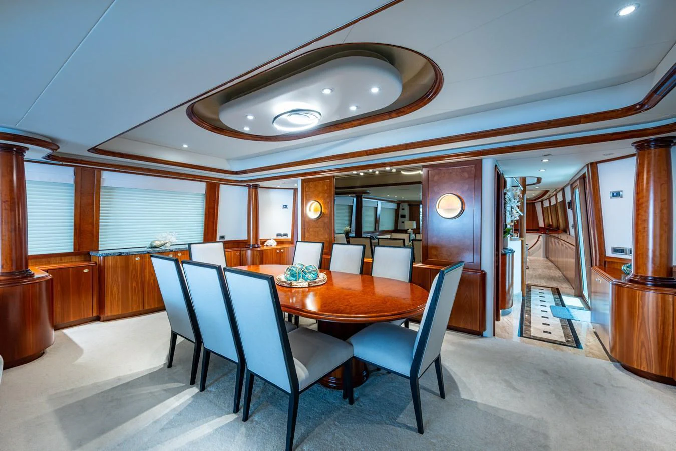 The yacht's dining area features elegant wood finishes and a spacious table with comfortable seating. aboard LILA CUY Yacht for Sale