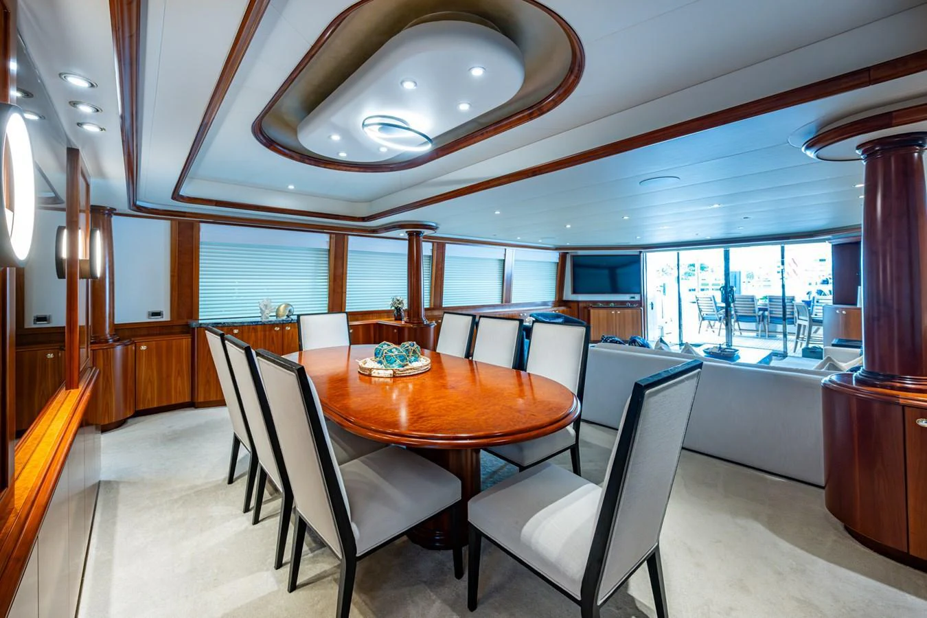 The yacht's dining area features elegant wood finishes and a spacious table for a refined dining experience. aboard LILA CUY Yacht for Sale