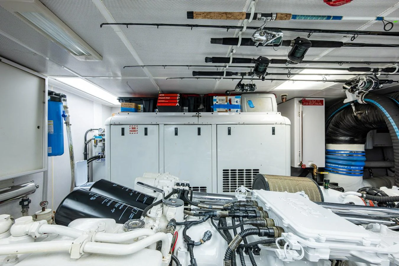 The image showcases the well-organized engine room of the yacht, highlighting the mechanical components and storage areas. aboard LILA CUY Yacht for Sale