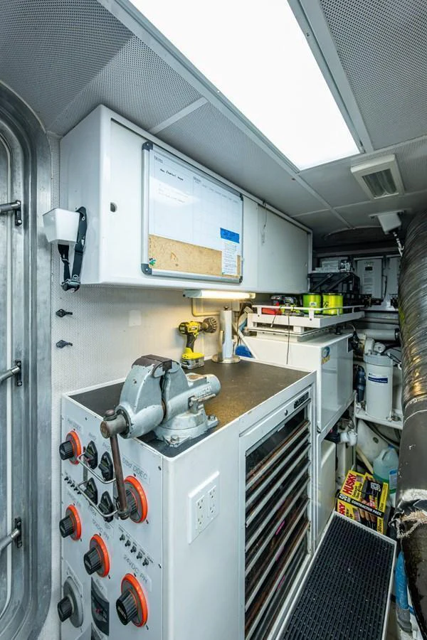 A well-equipped workshop area with various tools and equipment neatly organized. aboard LILA CUY Yacht for Sale
