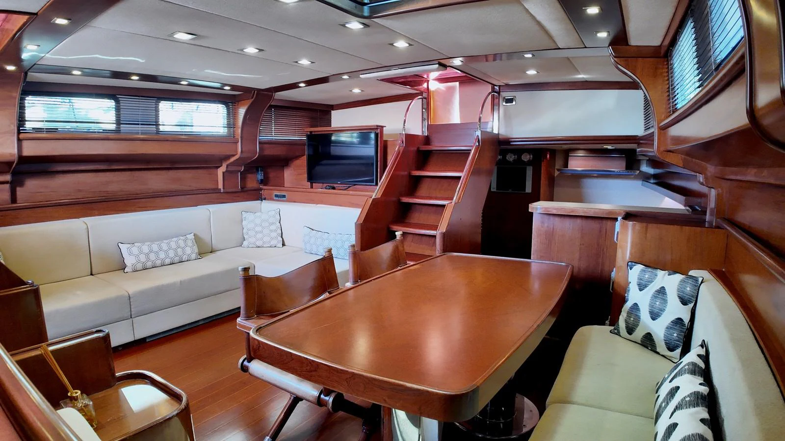 The saloon features elegant wood finishes, comfortable seating, and a dining area, creating a warm and inviting atmosphere. aboard PORTOBELLO Yacht for Sale