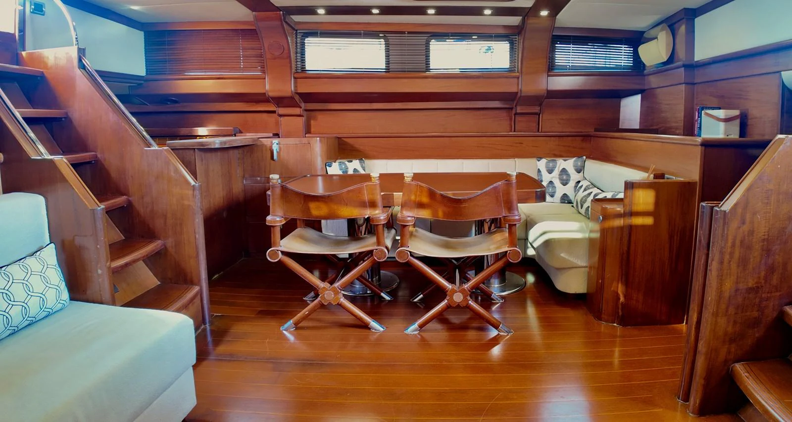 The yacht's salon features elegant wooden furnishings and comfortable seating, creating a warm and inviting atmosphere. aboard PORTOBELLO Yacht for Sale