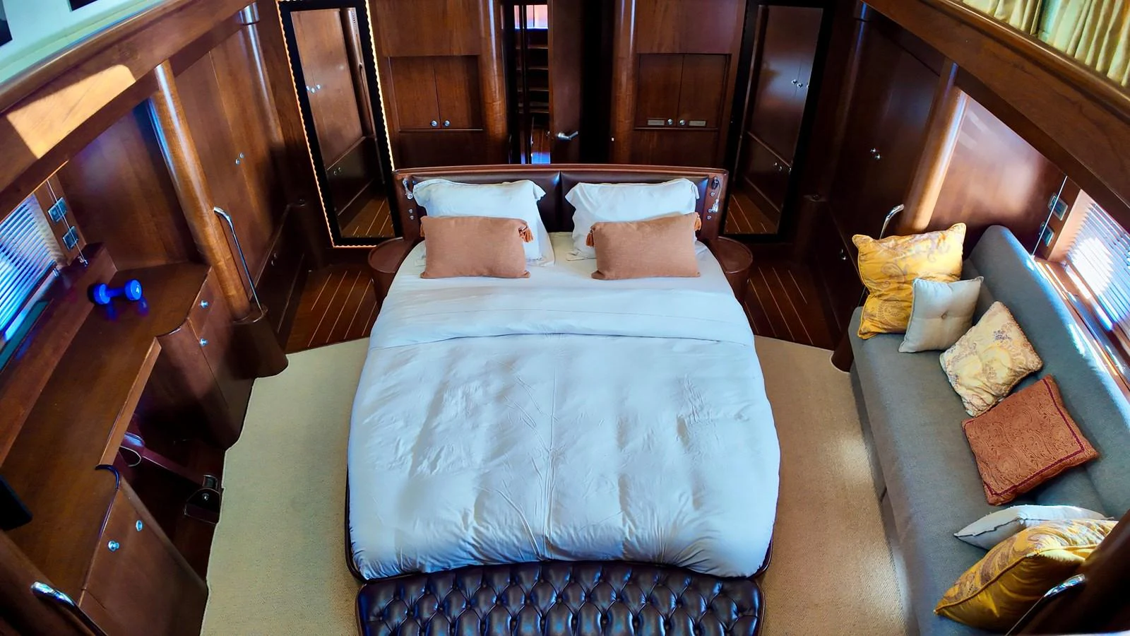 The master stateroom features a luxurious bed with plush pillows and elegant wooden furnishings. aboard PORTOBELLO Yacht for Sale