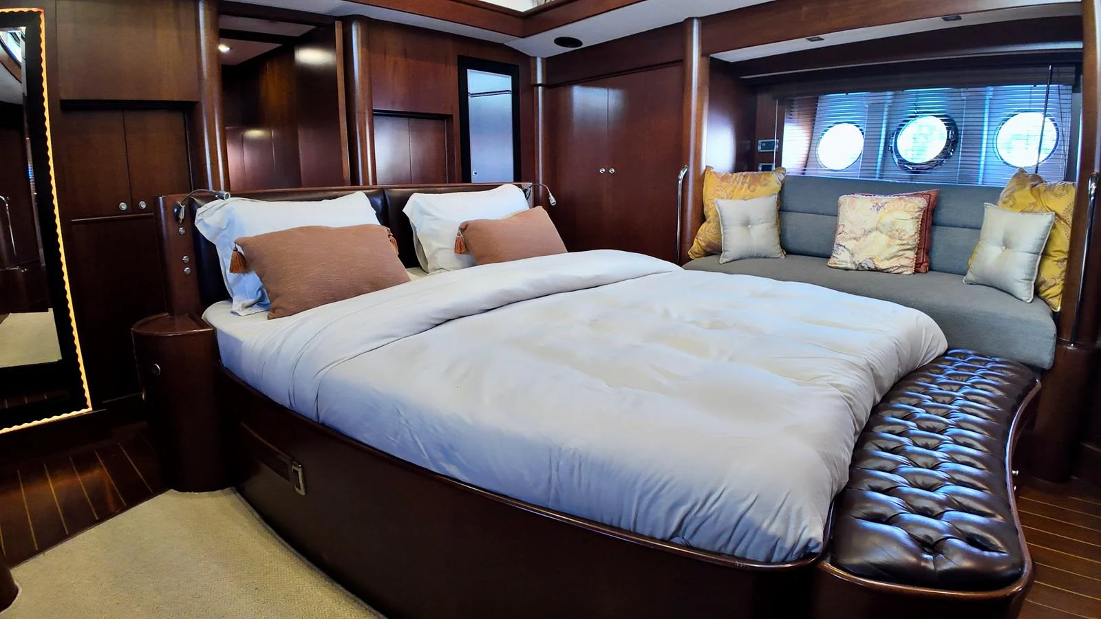 The master stateroom features a luxurious bed with plush pillows and elegant wood finishes. aboard PORTOBELLO Yacht for Sale