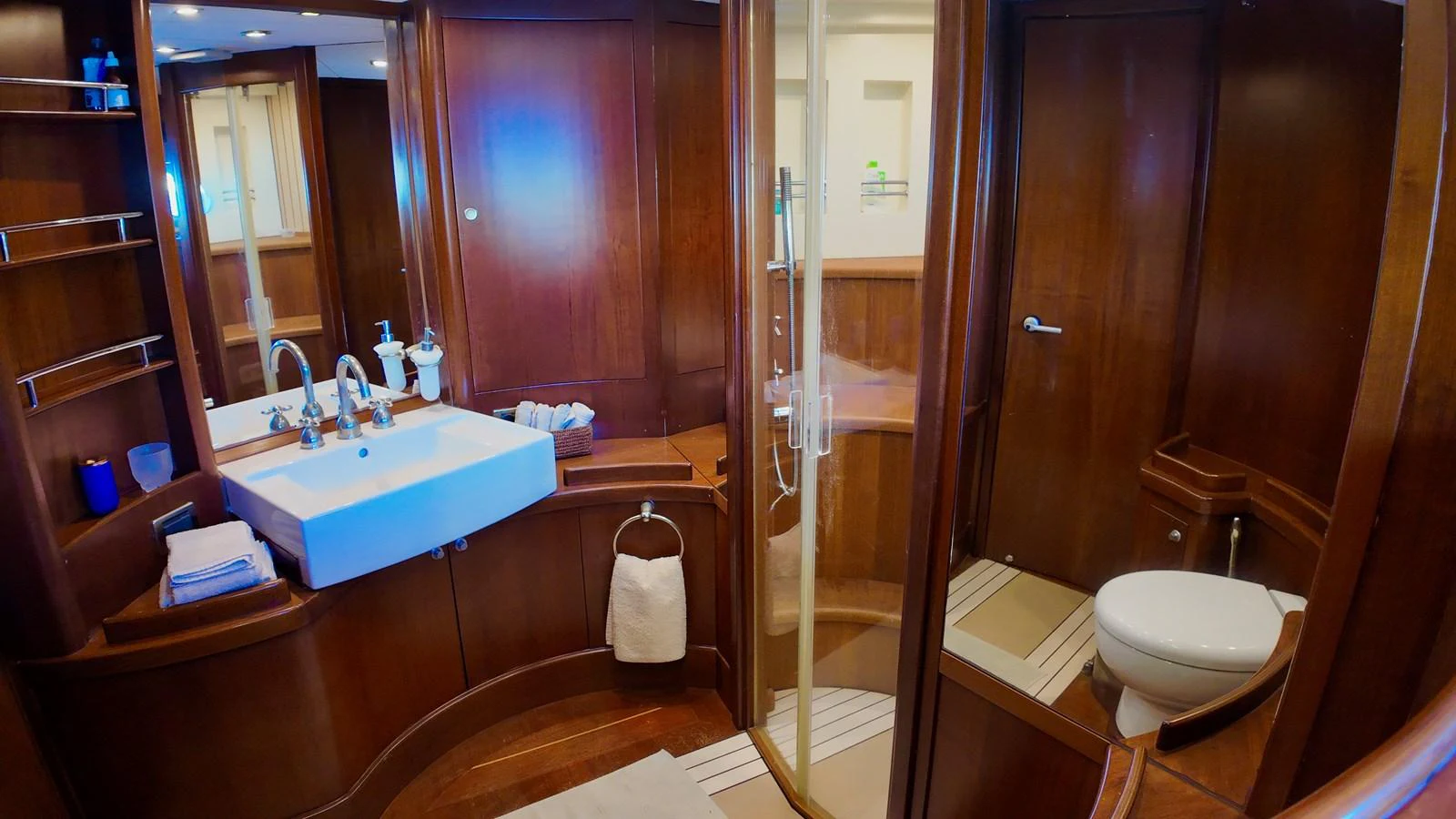 The yacht's bathroom features elegant wooden finishes and modern amenities. aboard PORTOBELLO Yacht for Sale