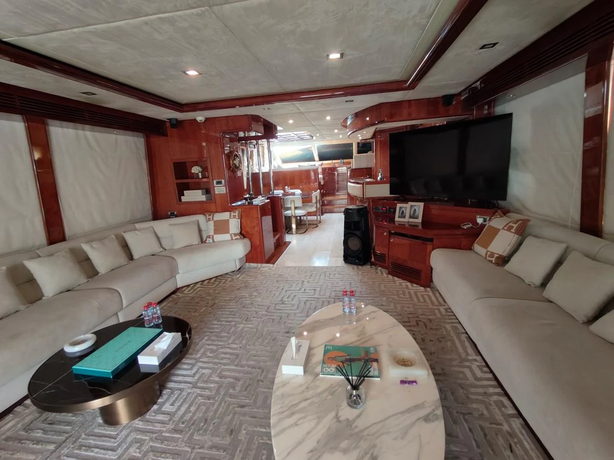 a living room with a couch and a television aboard HERMAS Yacht for Sale