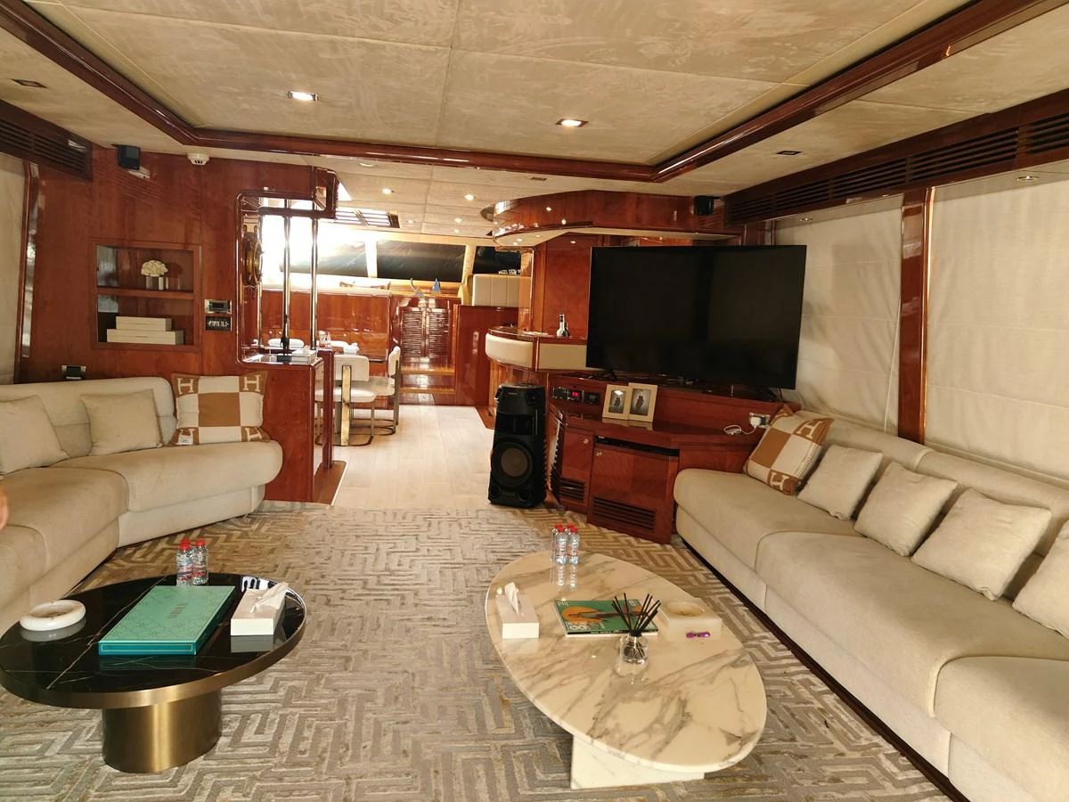 a living room with a couch and a television aboard HERMAS Yacht for Sale