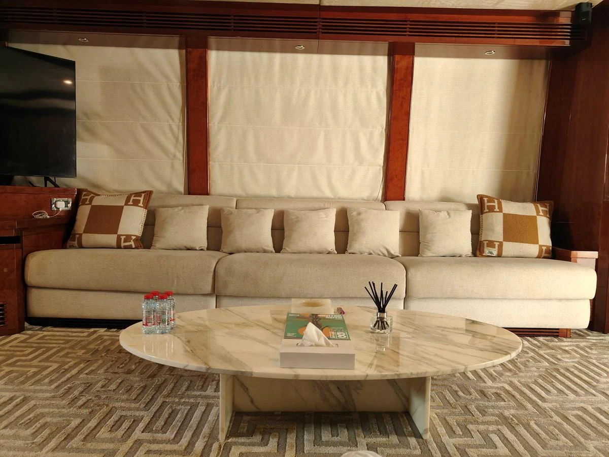 a living room with a couch and a table aboard HERMAS Yacht for Sale
