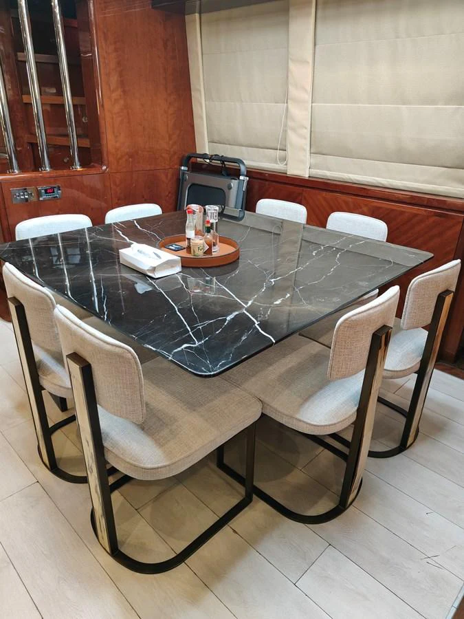 a table with chairs around it aboard HERMAS Yacht for Sale