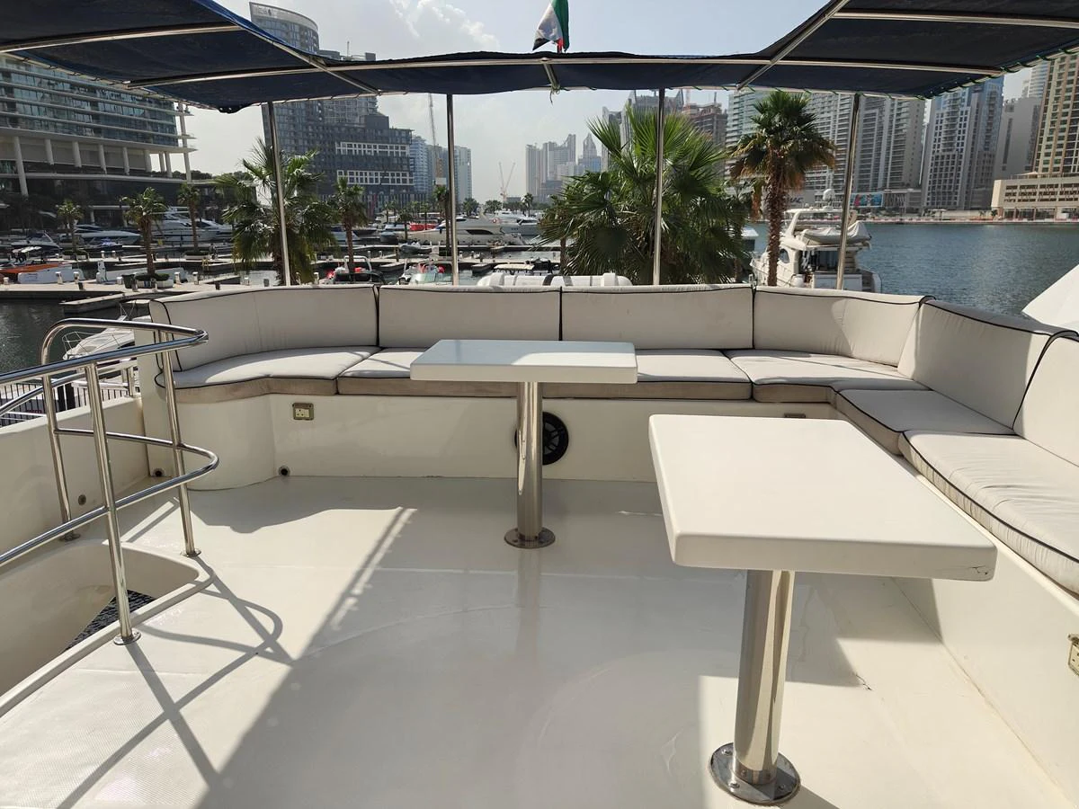 a table with benches on it aboard HERMAS Yacht for Sale