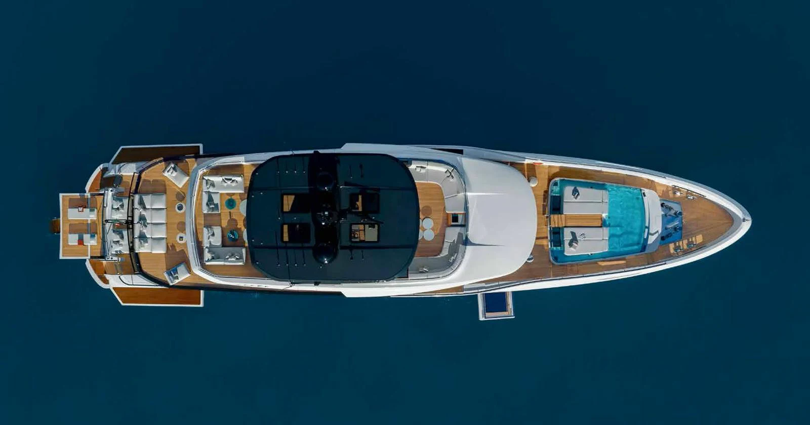 A stunning aerial view of a luxurious yacht showcasing its sleek design and spacious deck areas. aboard MANGUSTA OCEANO 44, #8 Yacht for Sale