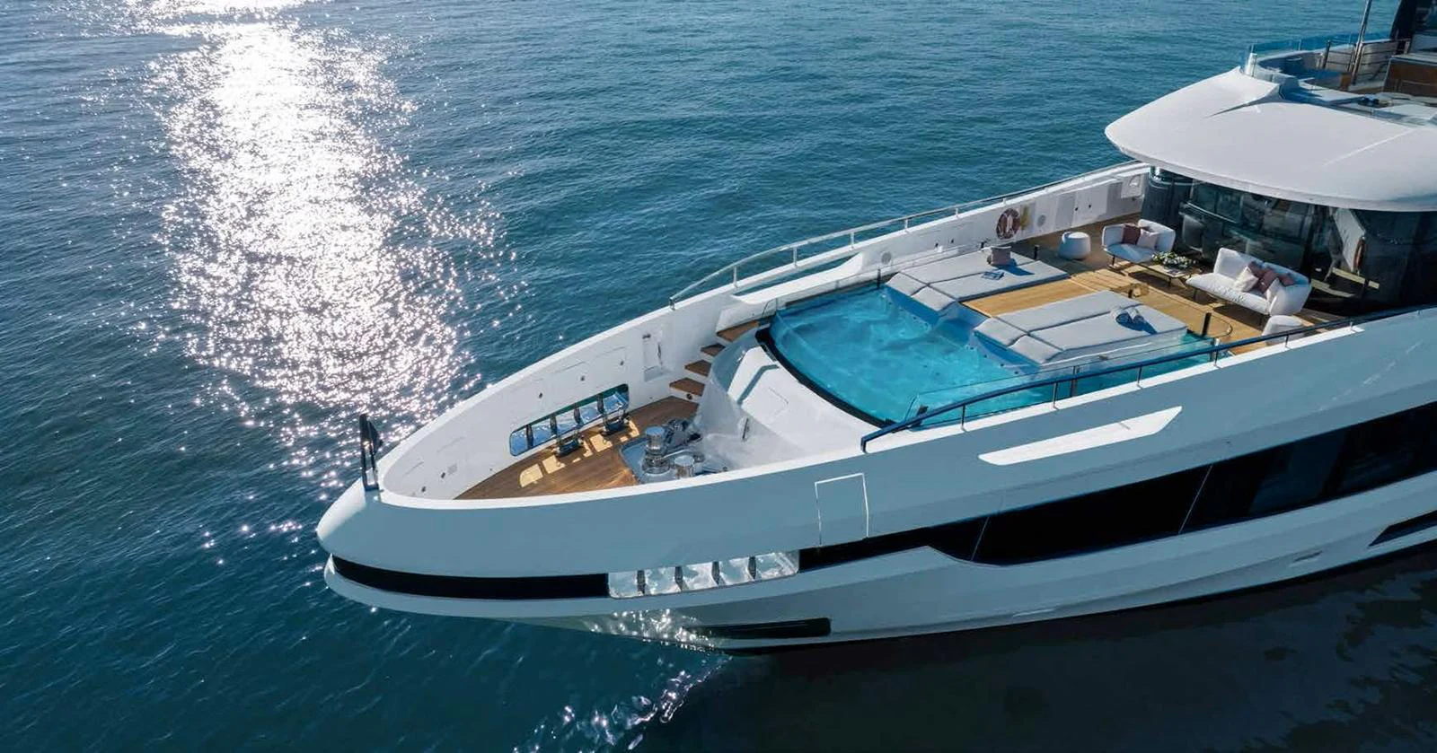 A luxurious yacht with a spacious deck and a stunning pool, cruising on calm waters. aboard MANGUSTA OCEANO 44, #8 Yacht for Sale
