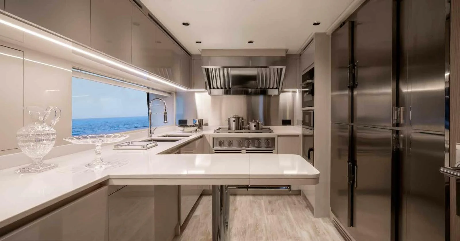 The yacht's galley features modern stainless steel appliances and sleek countertops with an ocean view. aboard MANGUSTA OCEANO 44, #8 Yacht for Sale