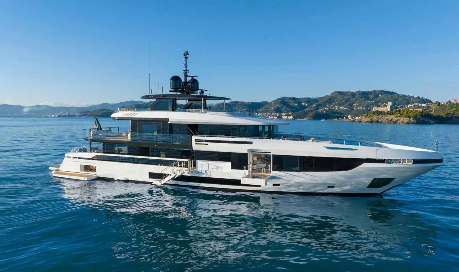 A sleek and modern yacht cruising on calm waters with a scenic coastal backdrop. aboard MANGUSTA OCEANO 44, #8 Yacht for Sale