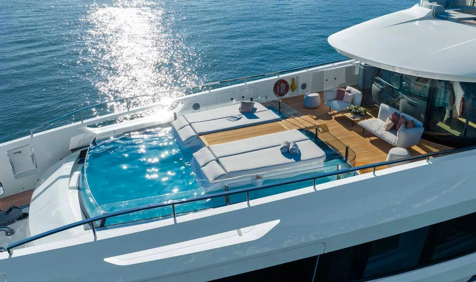 The sundeck features a luxurious pool surrounded by comfortable lounging areas. aboard MANGUSTA OCEANO 44, #8 Yacht for Sale