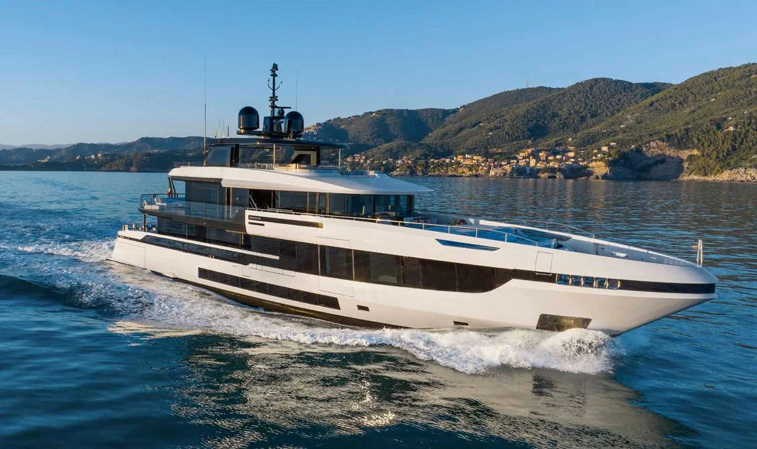 A sleek and modern yacht cruises through calm waters with scenic hills in the background. aboard MANGUSTA OCEANO 44, #8 Yacht for Sale