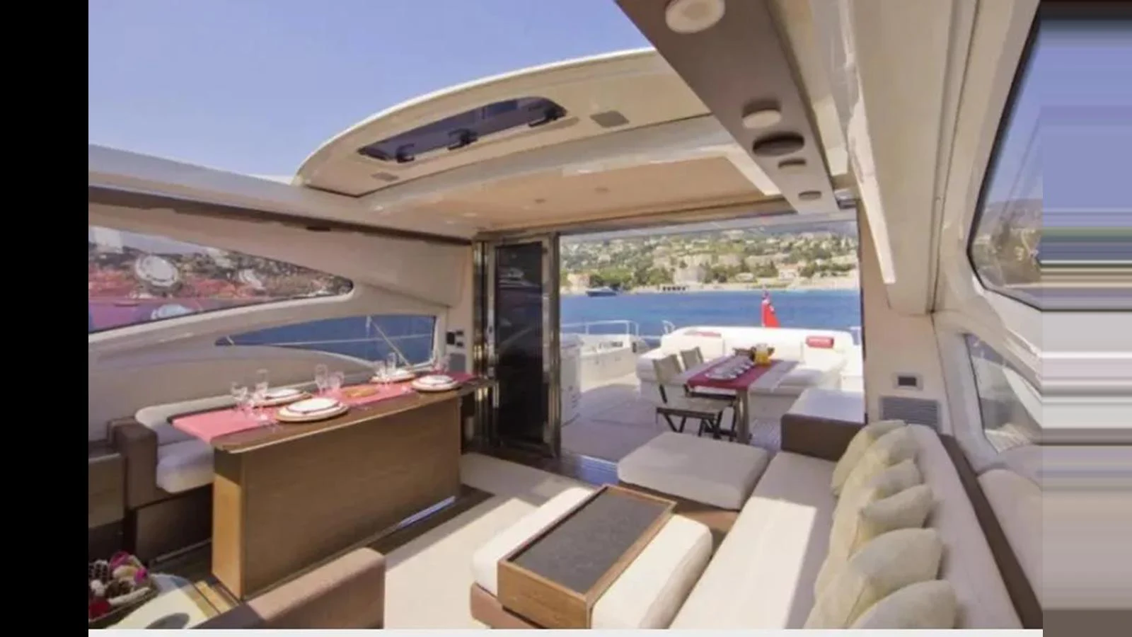 The salon offers a luxurious and open space with ample seating and a dining area, perfect for relaxation and entertainment. aboard 2007 AZIMUT 68S Yacht for Sale
