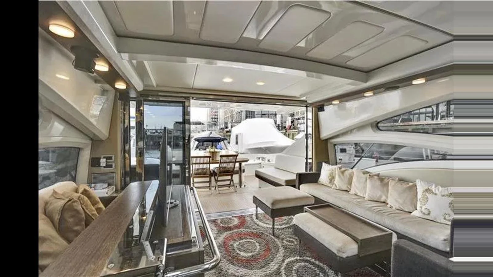 The salon offers a spacious and luxurious seating area with a view of the aft deck. aboard 2007 AZIMUT 68S Yacht for Sale