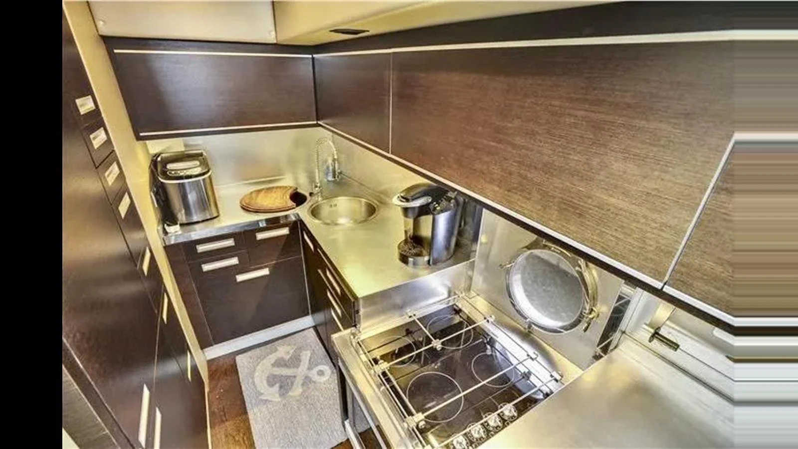 The yacht's galley is equipped with modern appliances and sleek cabinetry, offering a functional and stylish cooking space. aboard 2007 AZIMUT 68S Yacht for Sale