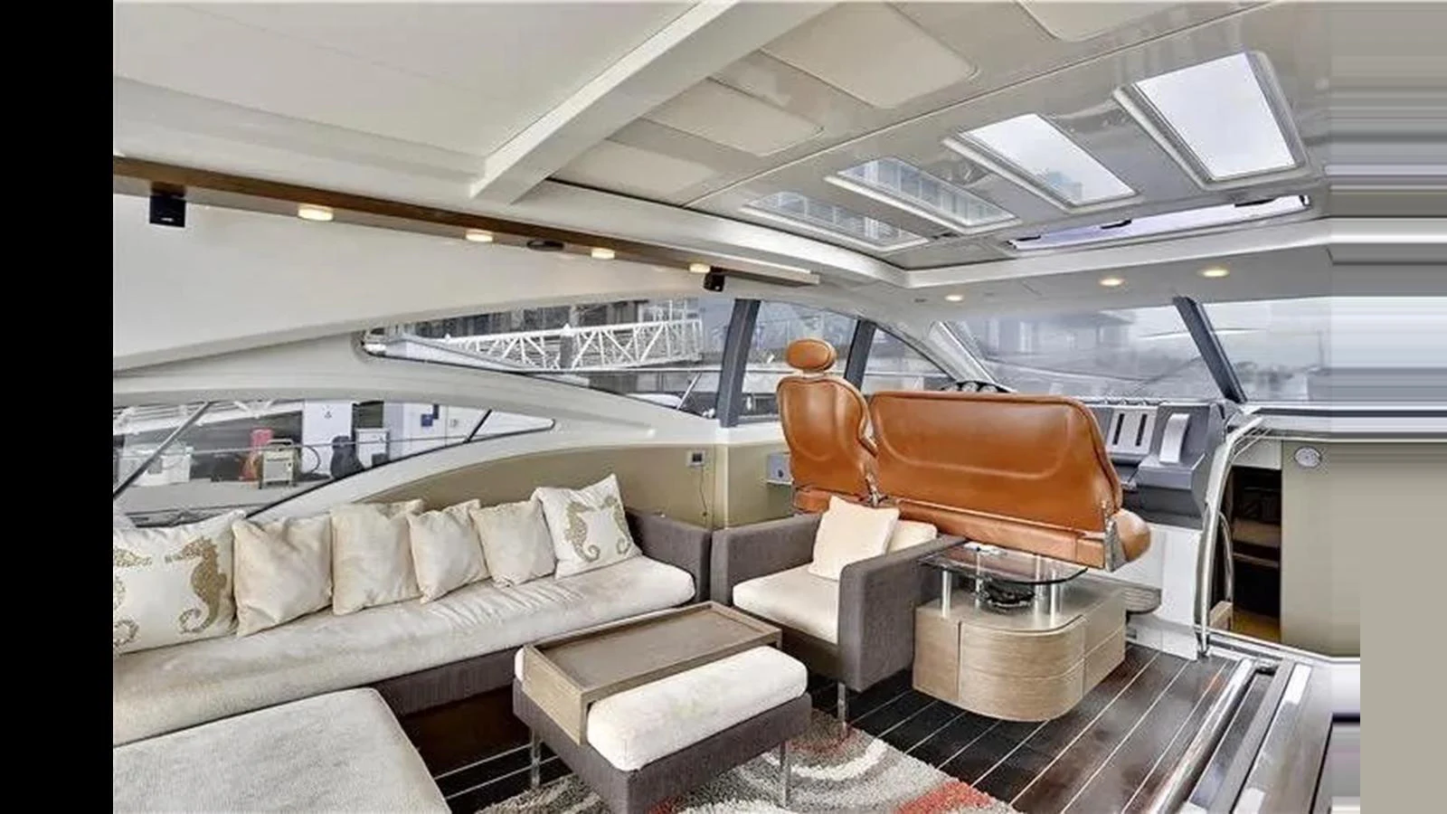 The salon features a luxurious seating area with a modern design and ample natural light. aboard 2007 AZIMUT 68S Yacht for Sale