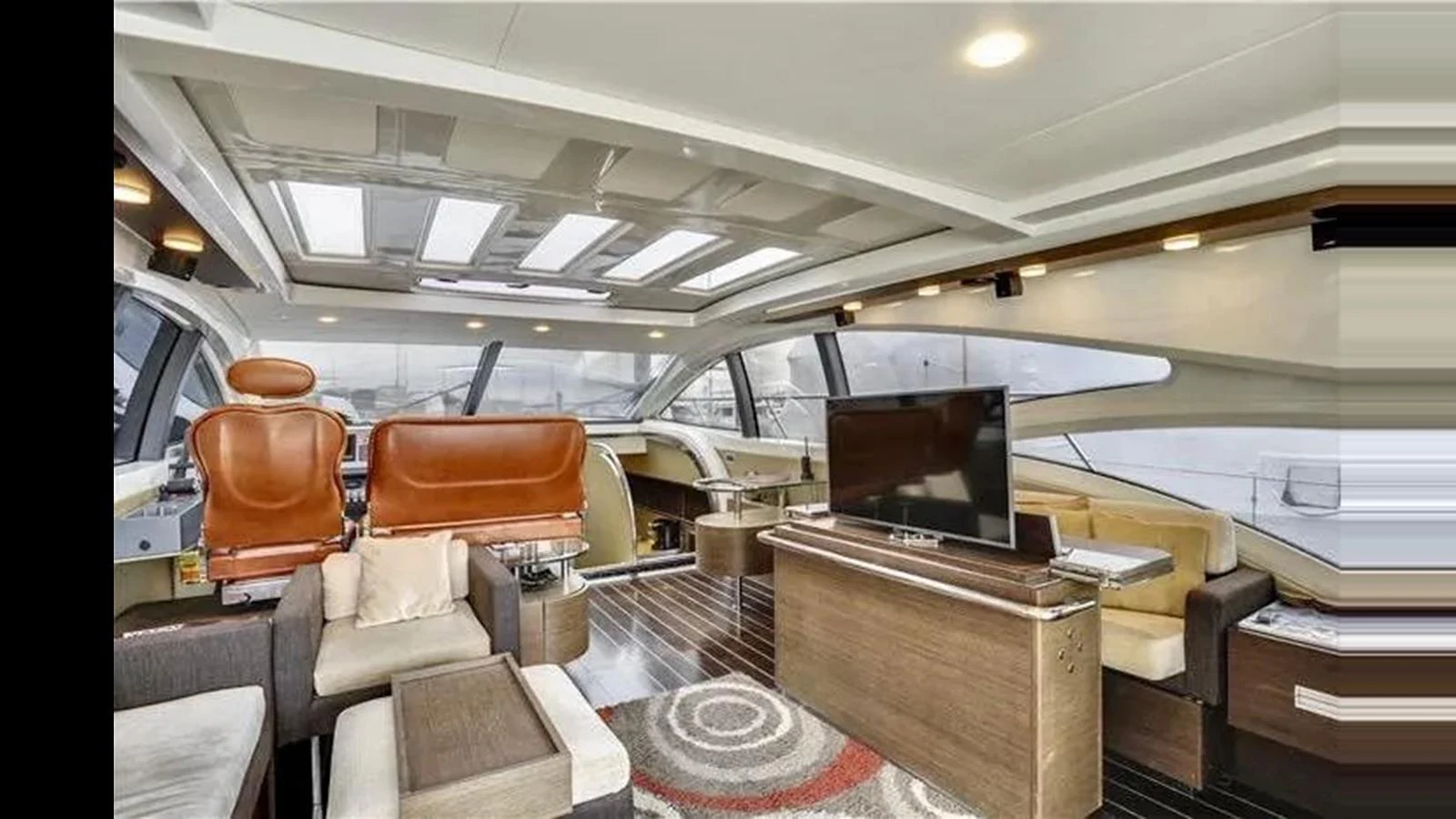The salon features modern furnishings with ample natural light from large windows and skylights. aboard 2007 AZIMUT 68S Yacht for Sale