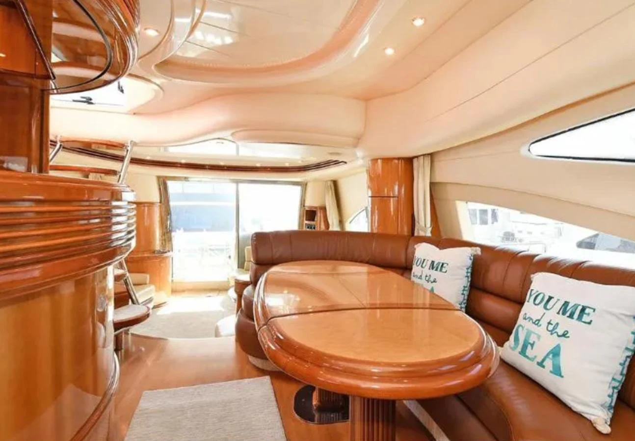 The salon features luxurious leather seating and elegant wood finishes, creating a warm and inviting atmosphere. aboard 2005 AZIMUT 68E Yacht for Sale