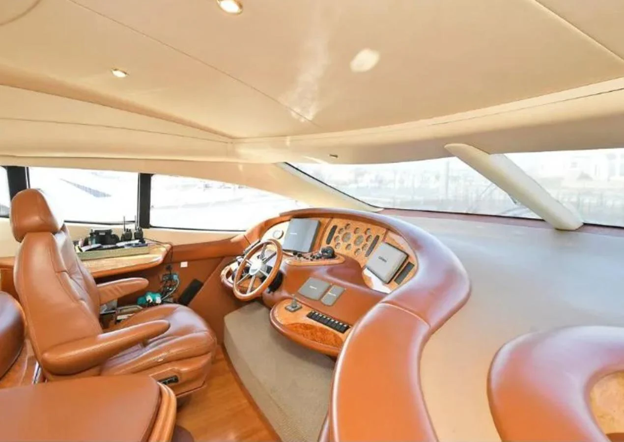 The helm station features luxurious leather seating and state-of-the-art navigation equipment. aboard 2005 AZIMUT 68E Yacht for Sale