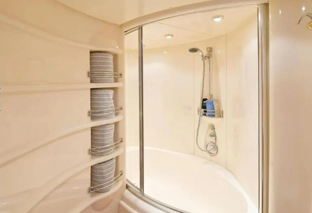 The yacht's bathroom features a spacious shower area with modern fixtures. aboard 2005 AZIMUT 68E Yacht for Sale
